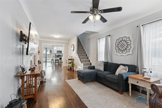 living room with dark hardwood / wood-style floors and ceiling fan