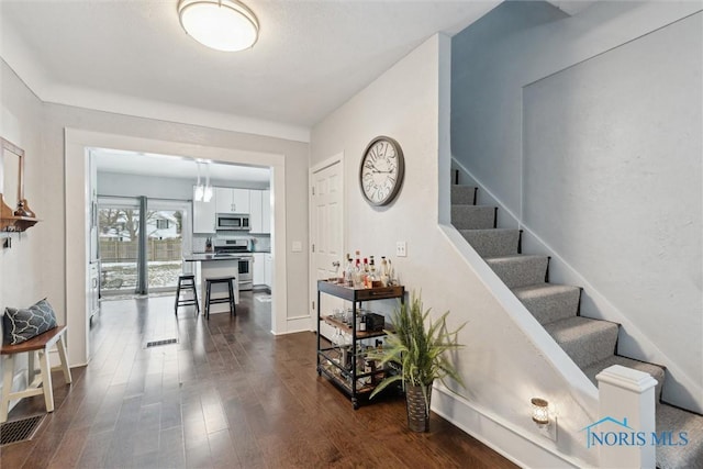 stairway featuring wood-type flooring