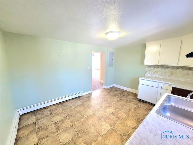 kitchen featuring a baseboard radiator, sink, white cabinets, backsplash, and electric panel