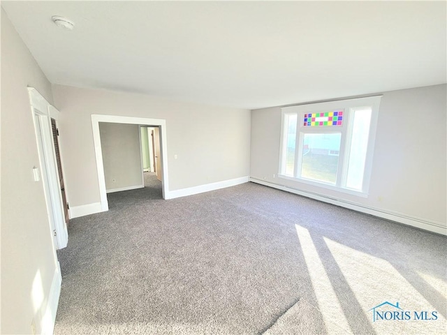 empty room with carpet floors and a baseboard radiator