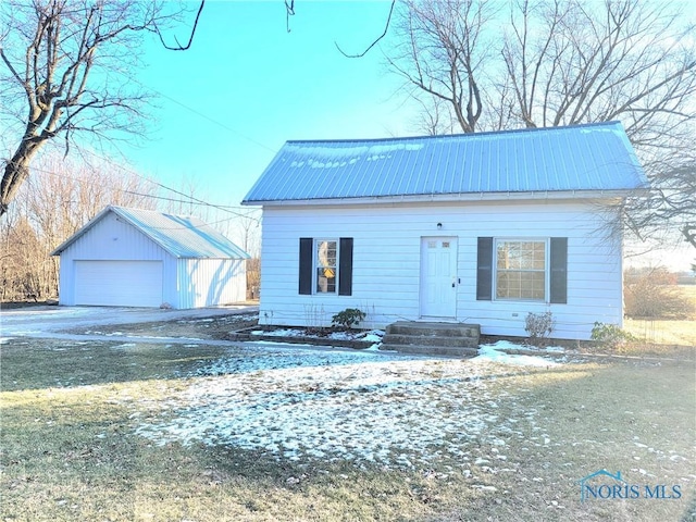 view of front of property with a garage and an outdoor structure