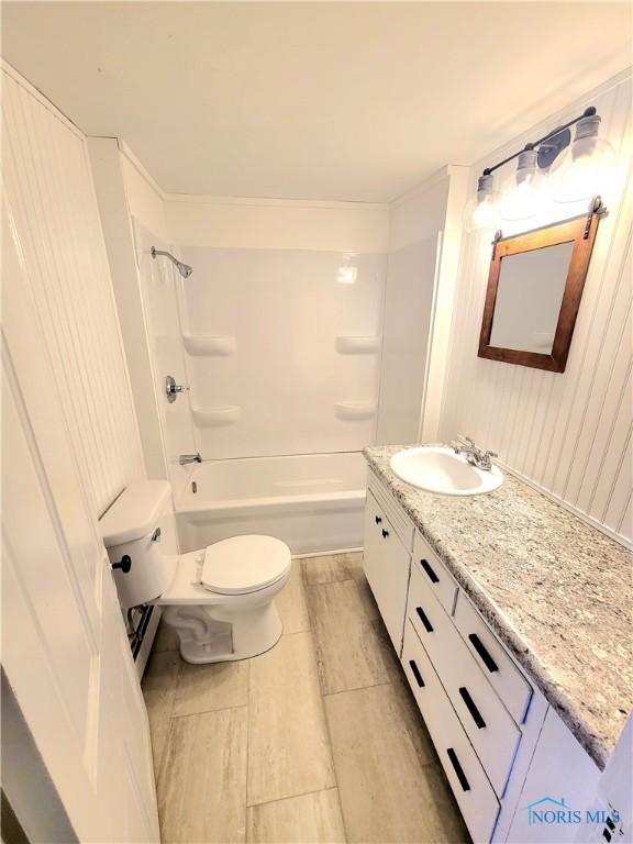 full bathroom with vanity, tub / shower combination, and toilet