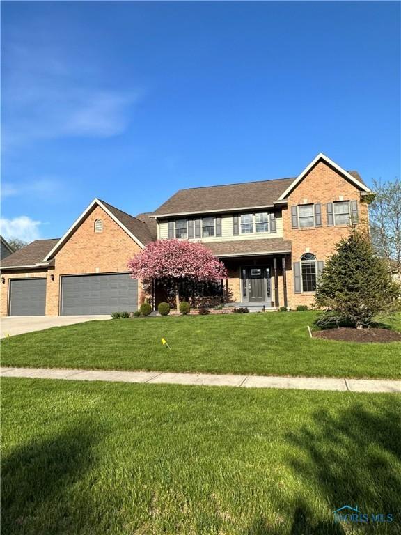 view of front of property with a garage and a front lawn