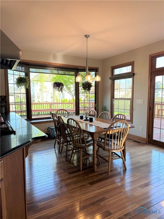 dining room with dark wood-type flooring