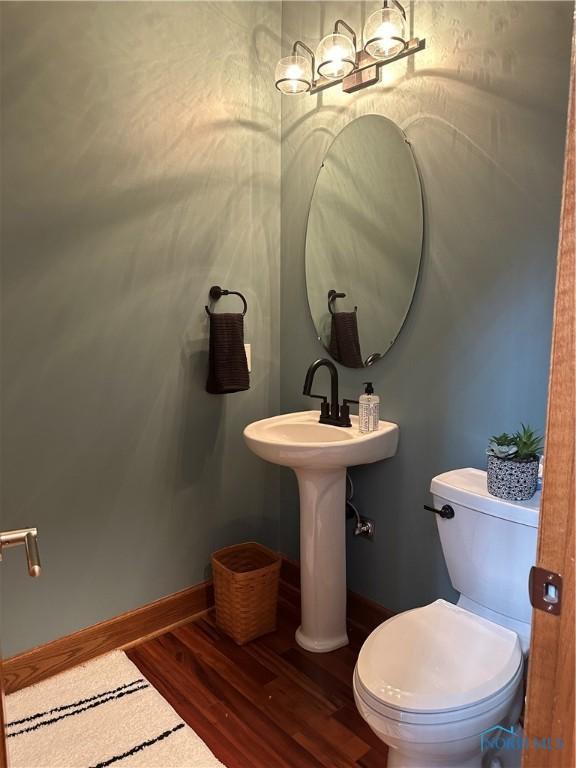 bathroom with wood-type flooring and toilet