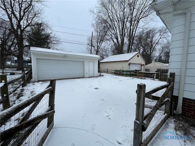 exterior space featuring a garage and an outbuilding