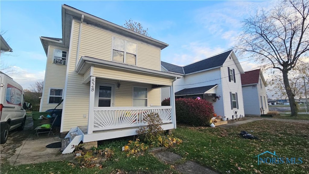 rear view of house featuring a porch