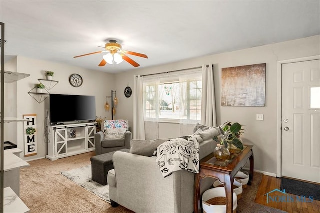 carpeted living room with ceiling fan