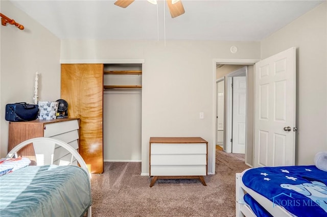 bedroom featuring light carpet, ceiling fan, and a closet