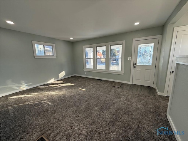 view of carpeted foyer entrance