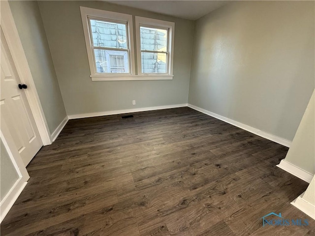 empty room with dark hardwood / wood-style floors