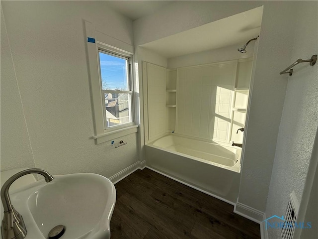 bathroom featuring shower / tub combination, sink, and hardwood / wood-style floors