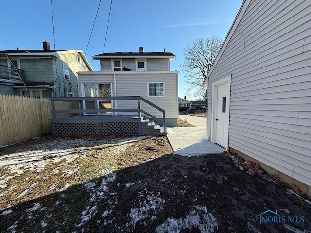 rear view of house with a wooden deck