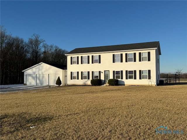 colonial house with a garage, cooling unit, and a front lawn