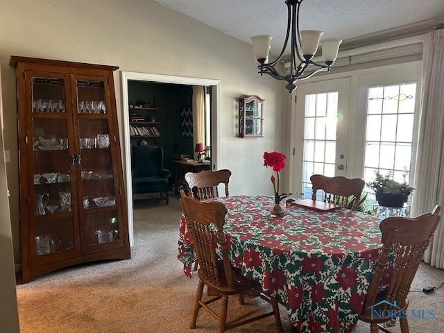 dining space featuring vaulted ceiling, a chandelier, light colored carpet, a textured ceiling, and french doors