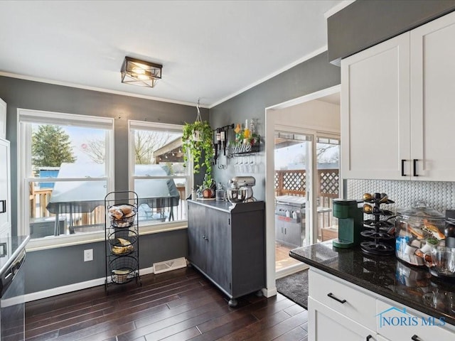 kitchen with a healthy amount of sunlight and white cabinets