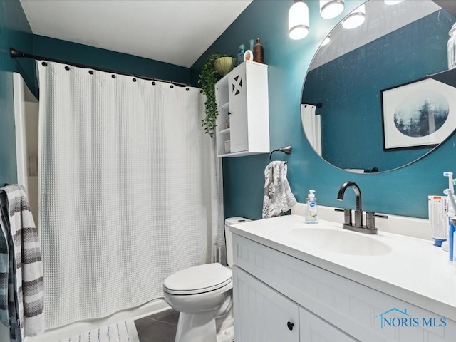 bathroom featuring vanity, toilet, and tile patterned flooring