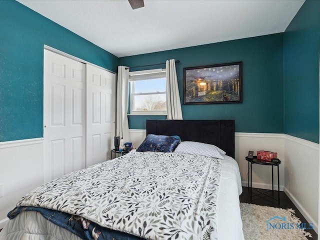 bedroom with ceiling fan and a closet