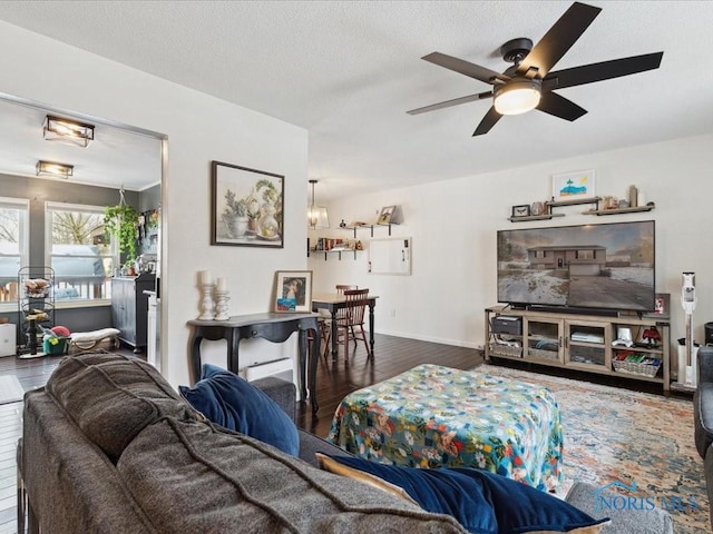 living room with ceiling fan, a textured ceiling, and dark hardwood / wood-style flooring