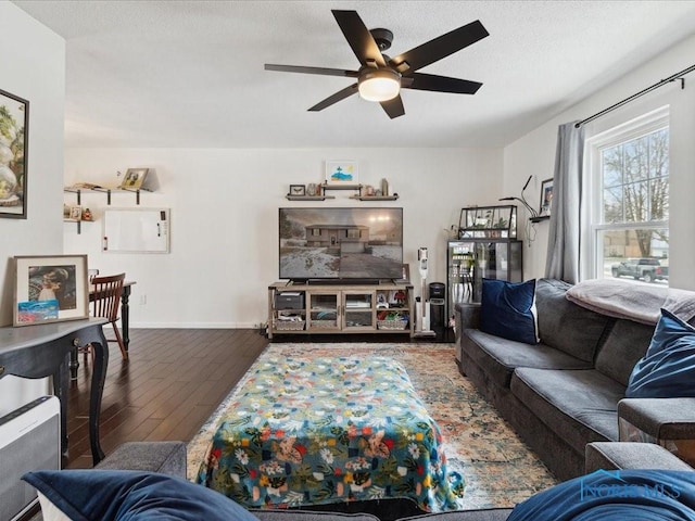 living room with ceiling fan and dark hardwood / wood-style flooring