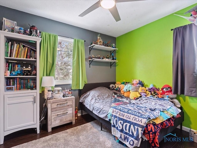 bedroom with dark wood-type flooring and ceiling fan