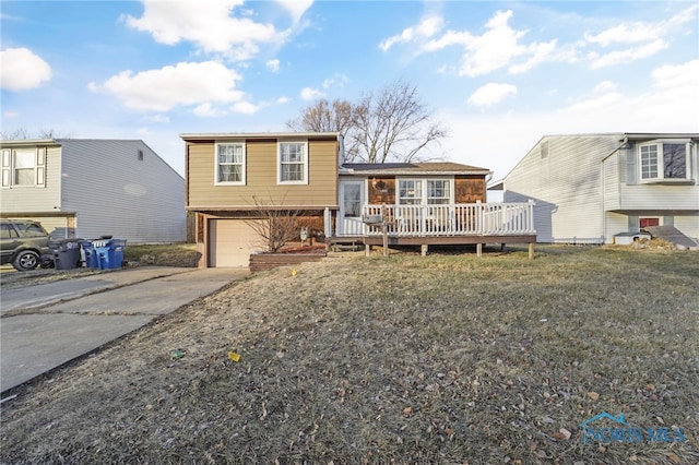 split level home featuring a garage, a front yard, and a deck