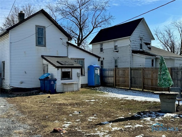 view of snow covered back of property