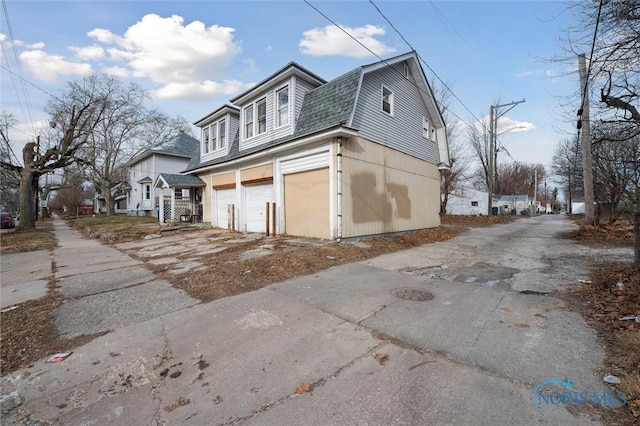 view of side of home with a garage