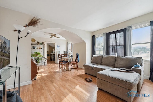 living room featuring ceiling fan and light hardwood / wood-style flooring