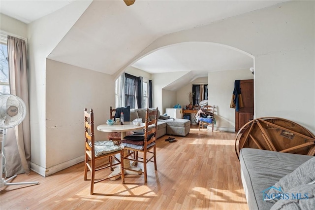 dining room with light hardwood / wood-style floors and vaulted ceiling