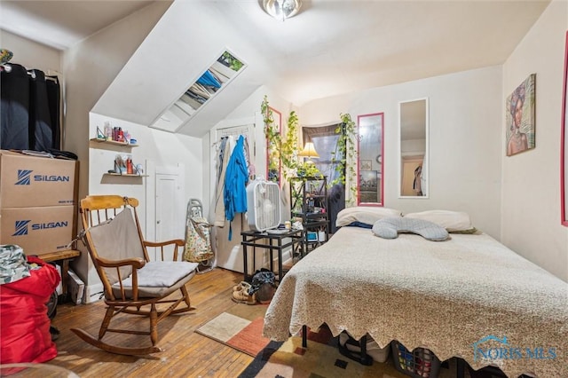 bedroom featuring lofted ceiling and wood-type flooring