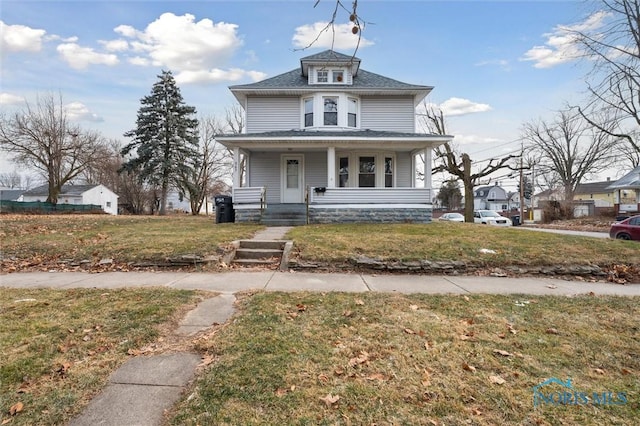 view of front of house with a porch and a front lawn