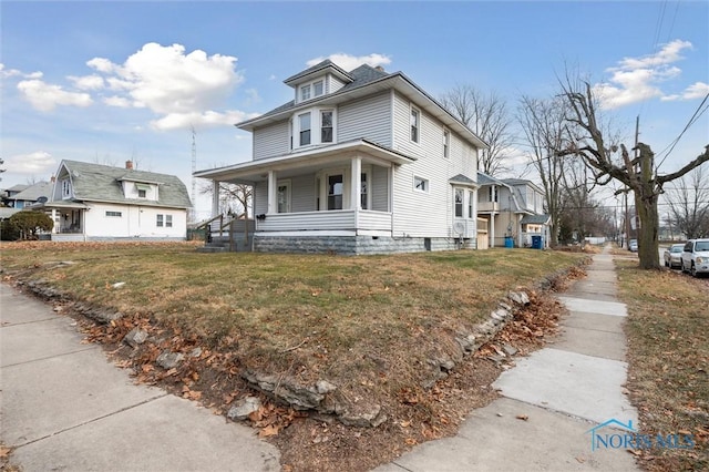 view of front facade with a front yard and covered porch