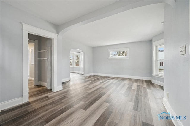 unfurnished living room with wood-type flooring