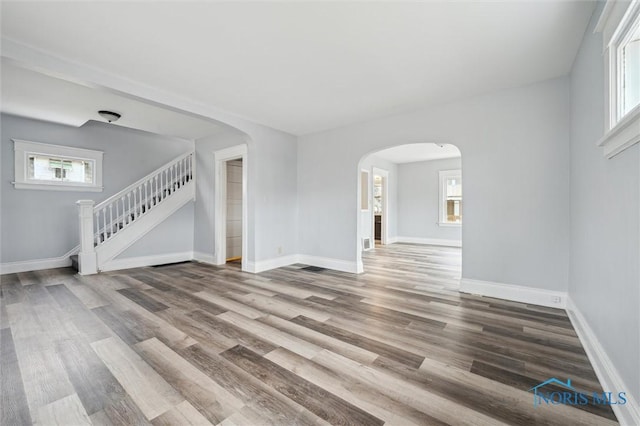 unfurnished living room featuring wood-type flooring