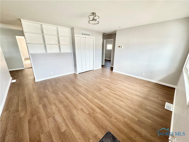 unfurnished bedroom featuring light hardwood / wood-style flooring and a closet