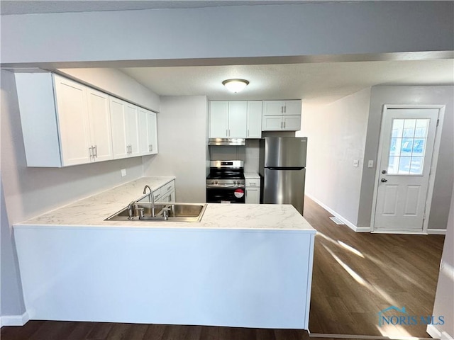 kitchen with dark hardwood / wood-style flooring, sink, white cabinets, and appliances with stainless steel finishes