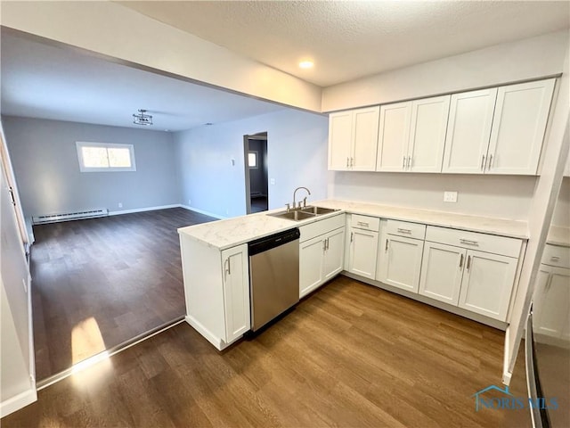 kitchen featuring sink, white cabinetry, a baseboard heating unit, stainless steel dishwasher, and kitchen peninsula