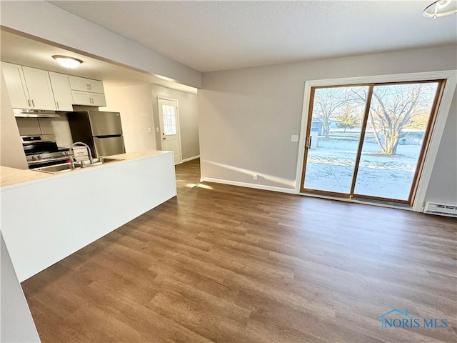 kitchen with white cabinetry, stainless steel appliances, sink, and dark wood-type flooring