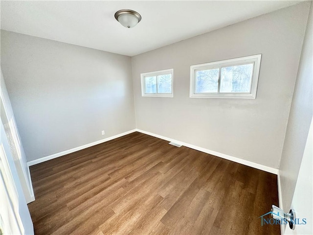 empty room with hardwood / wood-style floors