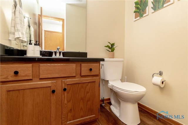 bathroom featuring hardwood / wood-style flooring, vanity, and toilet