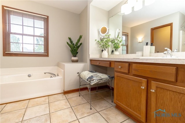 bathroom featuring a tub to relax in, vanity, and tile patterned flooring