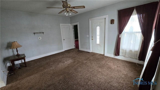 carpeted foyer entrance featuring ceiling fan