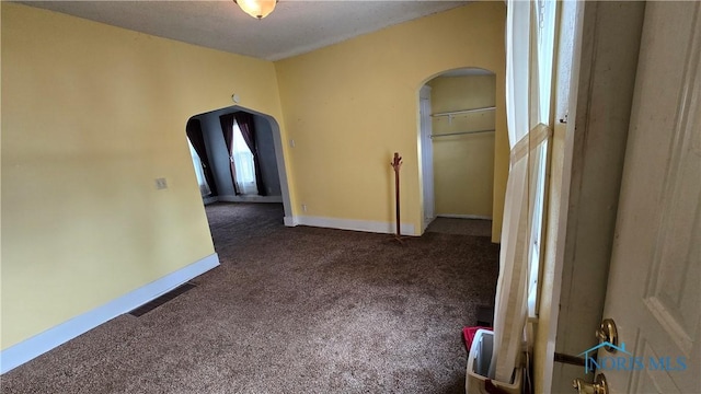 309 Appian Ave, Napoleon, OH 43545 - empty room featuring arched walkways, baseboards, visible vents, and carpet