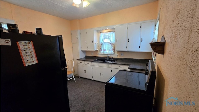 309 Appian Ave, Napoleon, OH 43545 - kitchen with white cabinets, dark countertops, a sink, dark carpet, and black appliances