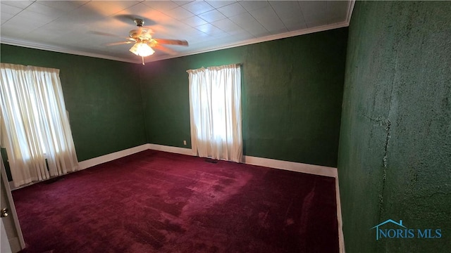 unfurnished room with a healthy amount of sunlight, carpet floors, and crown molding