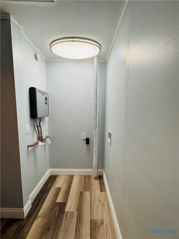 corridor featuring hardwood / wood-style flooring and ornamental molding