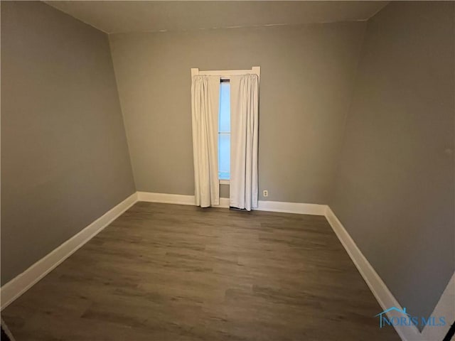 unfurnished room with wood-type flooring