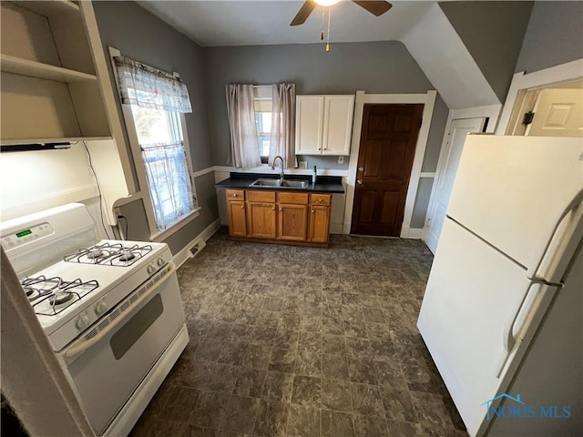 kitchen with ceiling fan, lofted ceiling, sink, and white appliances