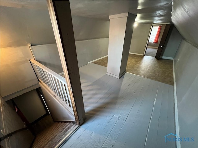 interior space with lofted ceiling and hardwood / wood-style flooring